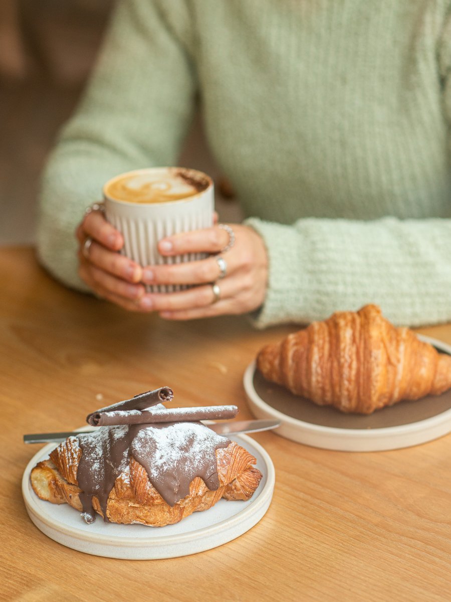 Barista preparing coffee behind the counter