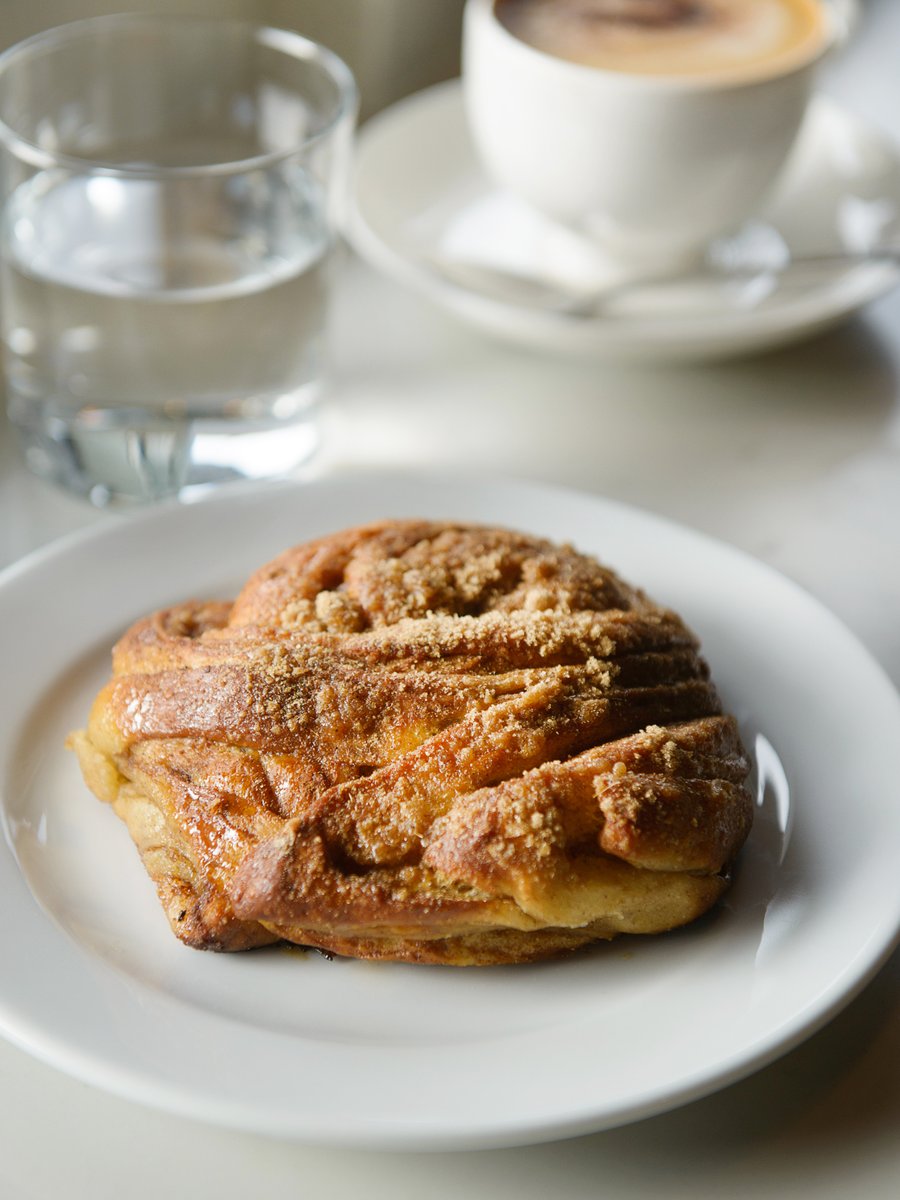 Slice of cake topped with fresh berries and cream